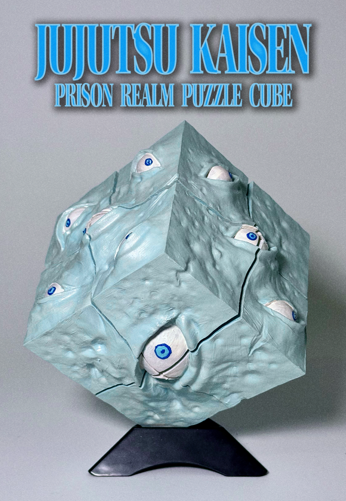 A 3D jigsaw puzzle cube titled 'Jujutsu Kaisen Prison Realm Puzzle Cube' displayed on a black stand. The cube is a light icy blue color with raised, organic eye-like details featuring blue and black pupils.
